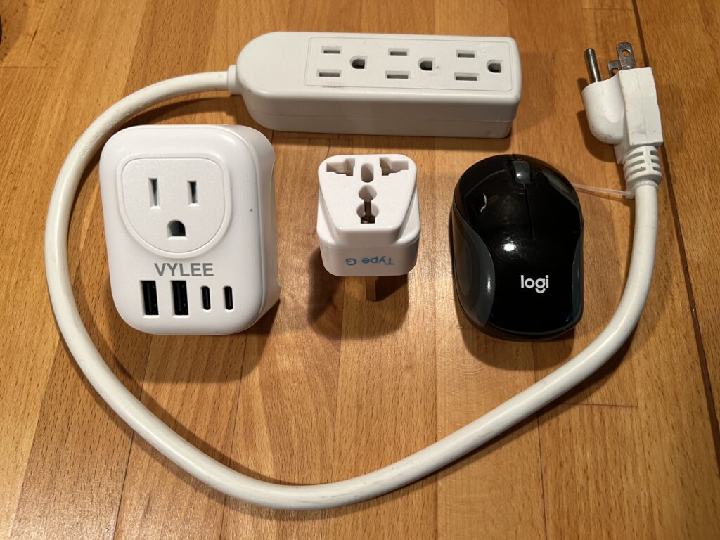 AC adapters for traveling various countries and a small mouse for wor